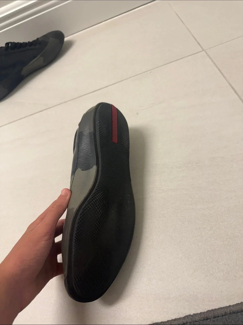 Prada Black Low-Top Leather Sneaker with Red Tongue Accent